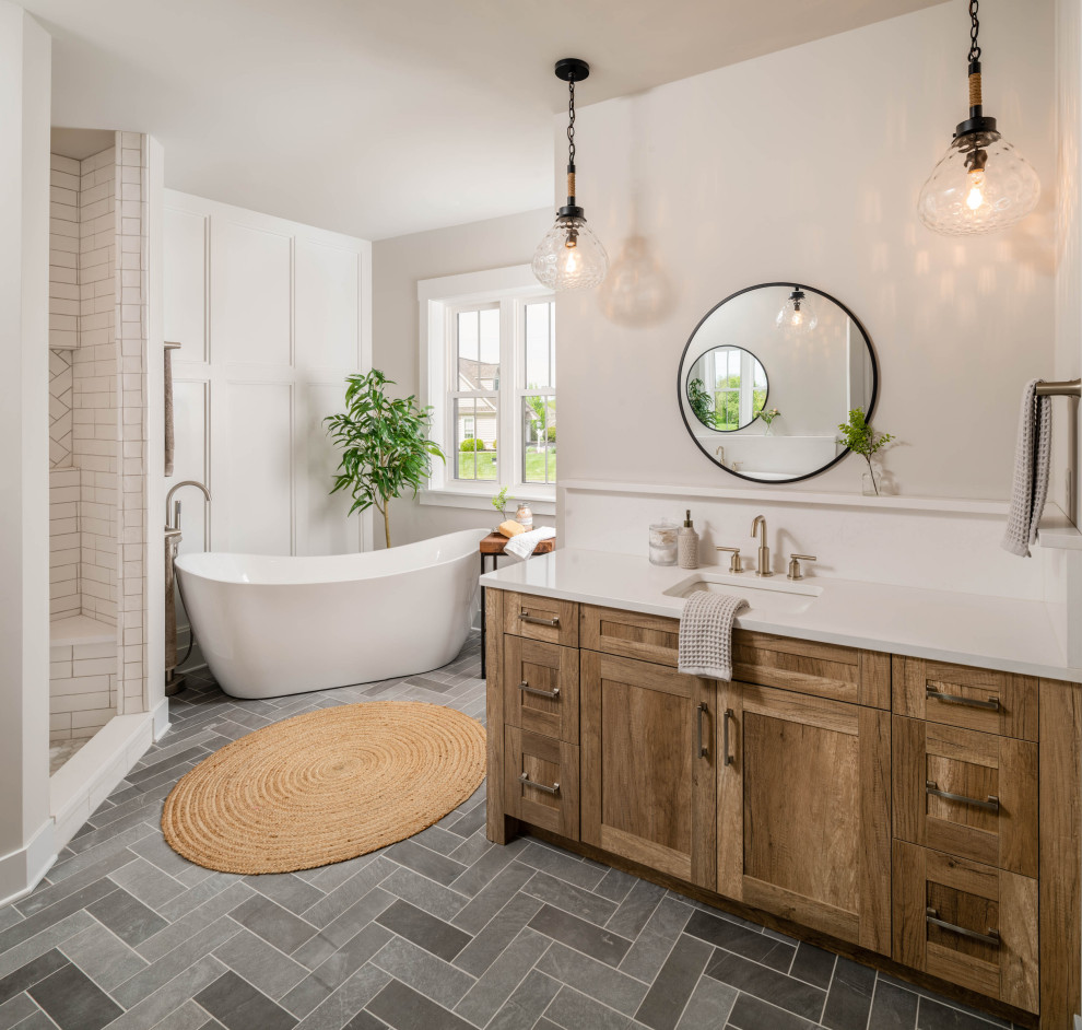 Freestanding bathtub - cottage gray floor, single-sink and wall paneling freestanding bathtub idea in Philadelphia with shaker cabinets, medium tone wood cabinets, white walls, an undermount sink, white countertops and a built-in vanity