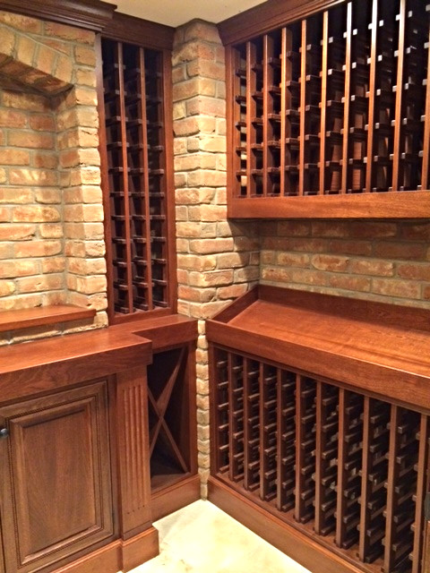 This is an example of a small traditional wine cellar in Philadelphia with storage racks.