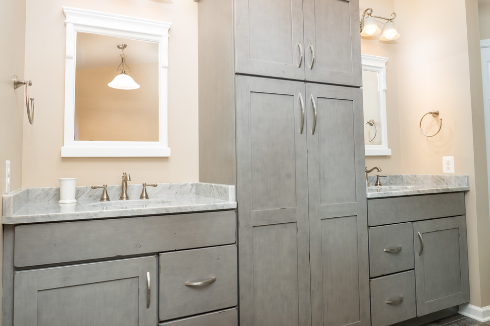 Photo of a mid-sized traditional master bathroom in Baltimore with recessed-panel cabinets, grey cabinets, a freestanding tub, a curbless shower, a two-piece toilet, beige tile, ceramic tile, beige walls, porcelain floors, an undermount sink, granite benchtops, brown floor and a hinged shower door.
