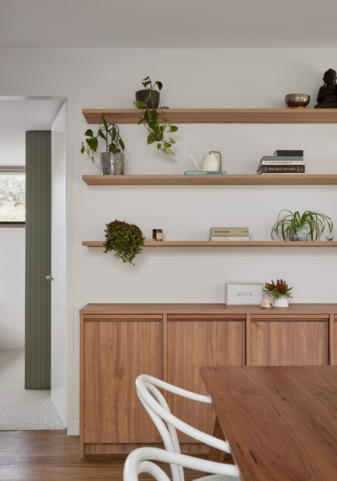 Photo of a mid-sized beach style kitchen/dining combo in Melbourne with medium hardwood floors.