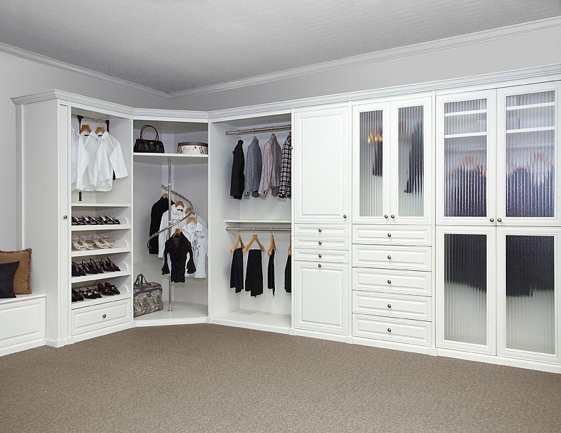 Design ideas for a large traditional women's dressing room in Miami with raised-panel cabinets, white cabinets, carpet and brown floor.