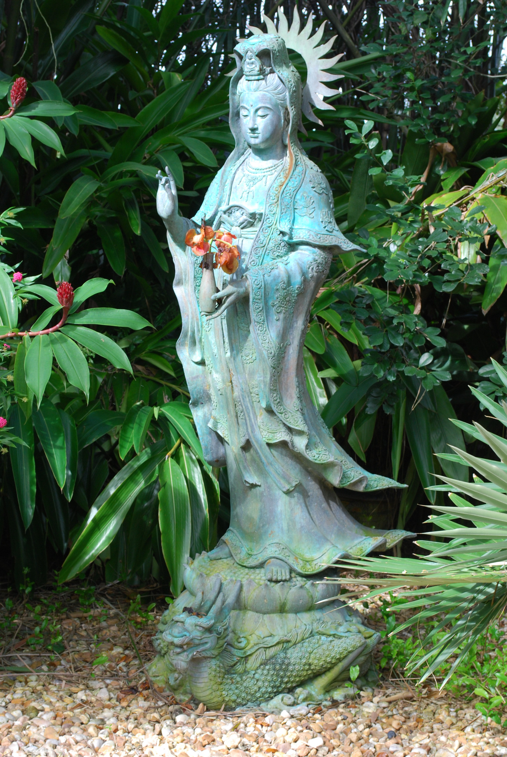 Asian sculpture brings tranquility to garden.