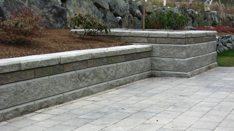 This is an example of a mid-sized backyard concrete paver retaining wall landscape in Seattle.