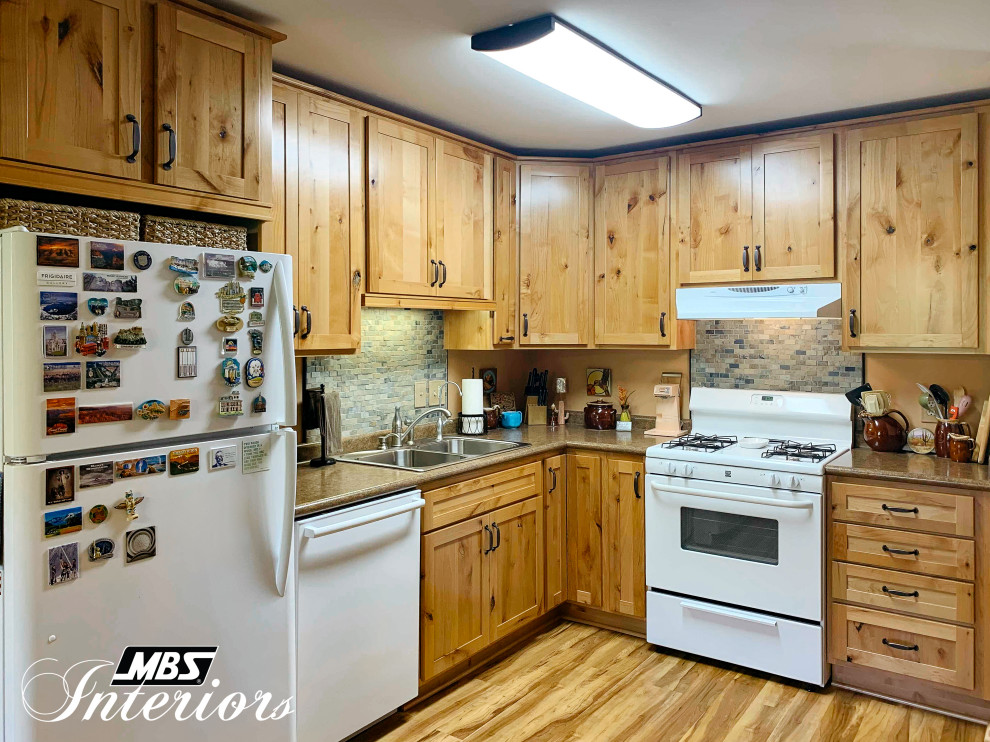 Eat-in kitchen - mid-sized rustic l-shaped light wood floor and beige floor eat-in kitchen idea with a drop-in sink, shaker cabinets, light wood cabinets, laminate countertops, multicolored backsplash, stone tile backsplash, white appliances, no island and brown countertops