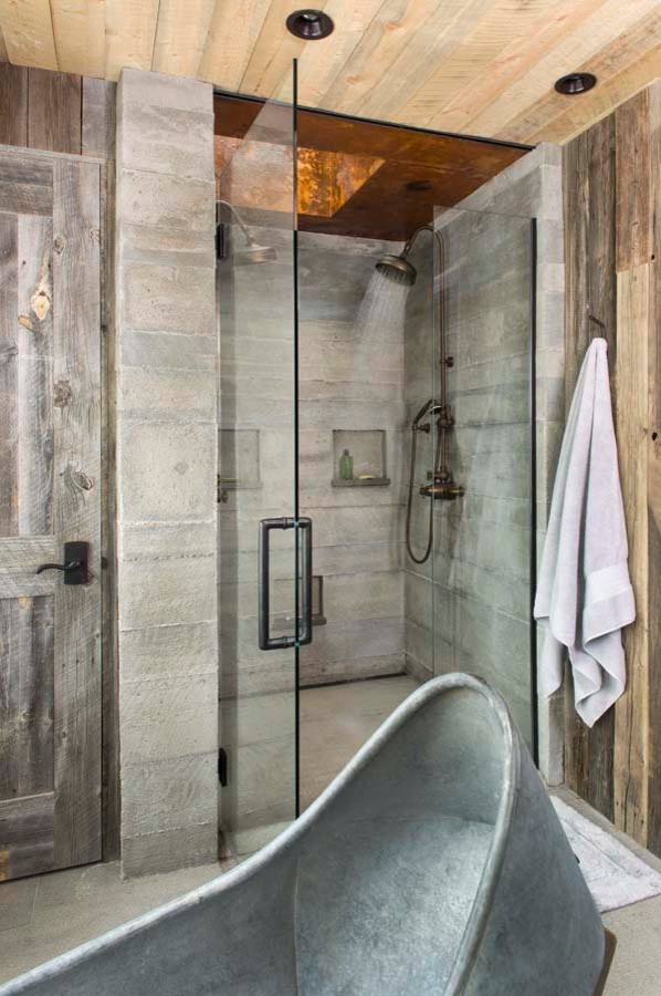 Photo of a large country master bathroom in Denver with open cabinets, medium wood cabinets, a freestanding tub, an open shower, gray tile, stone tile, brown walls and wood benchtops.