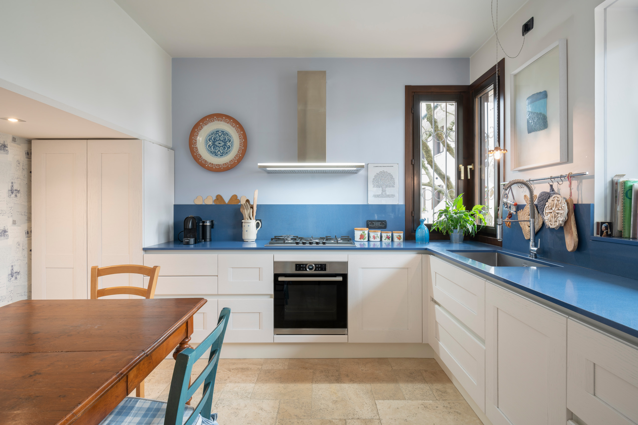 Foto di una cucina a L classica chiusa e di medie dimensioni con lavello da incasso, ante con riquadro incassato, ante bianche, top in marmo, paraspruzzi blu, paraspruzzi in marmo, elettrodomestici in