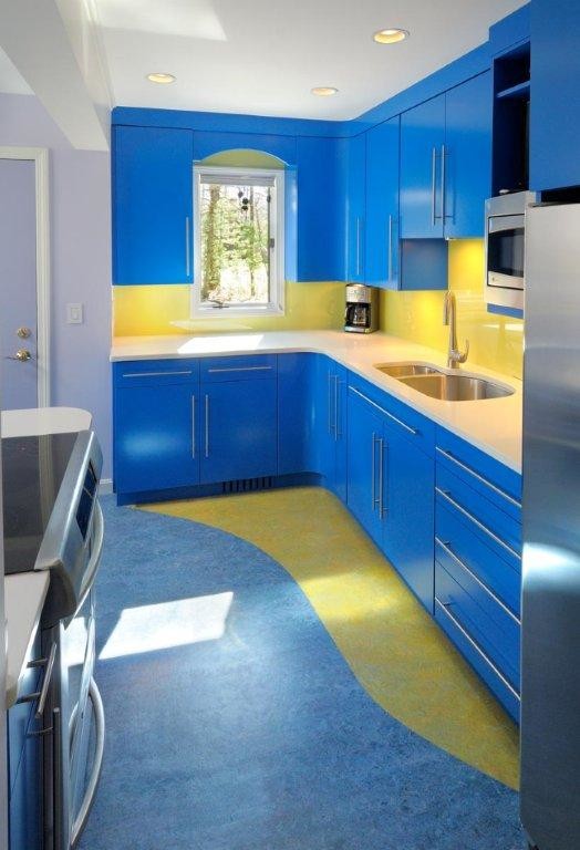 Photo of a contemporary kitchen in New York with flat-panel cabinets, blue cabinets, quartz benchtops, yellow splashback and glass sheet splashback.