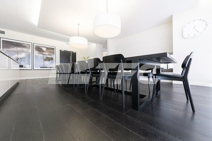 Inspiration for a large modern kitchen/dining combo in Melbourne with black walls.
