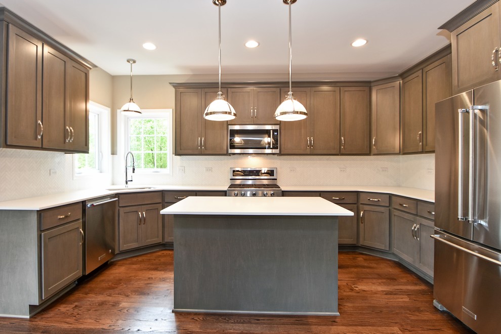 Example of a mid-sized transitional u-shaped dark wood floor eat-in kitchen design in Chicago with an undermount sink, recessed-panel cabinets, dark wood cabinets, white backsplash, stainless steel appliances and an island