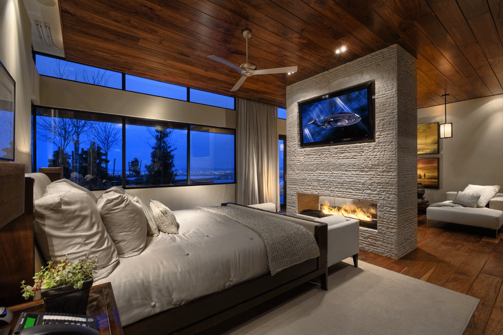 Photo of a contemporary bedroom in Las Vegas with a ribbon fireplace.