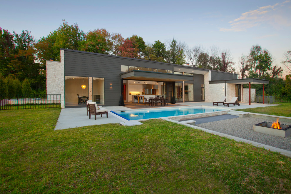 Photo of a modern exterior in Cincinnati with stone veneer and a flat roof.