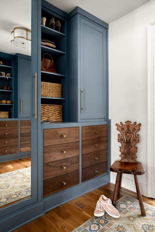 Inspiration for a transitional women's walk-in wardrobe in Atlanta with shaker cabinets, blue cabinets, dark hardwood floors and brown floor.