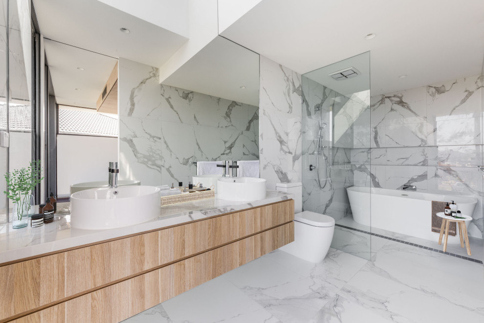 Inspiration for a mid-sized contemporary master bathroom in Melbourne with light wood cabinets, a corner tub, an open shower, white tile, marble, white walls, marble floors, a vessel sink, marble benchtops, white floor, a double vanity, a floating vanity and flat-panel cabinets.