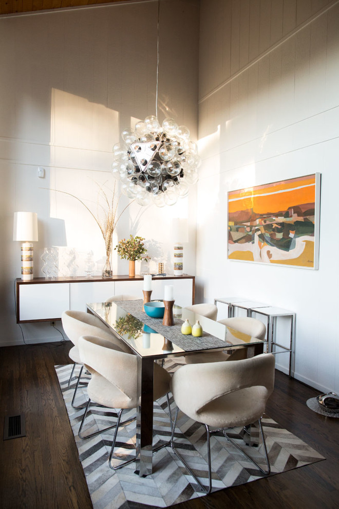 This is an example of a contemporary dining room in San Francisco with white walls and dark hardwood floors.