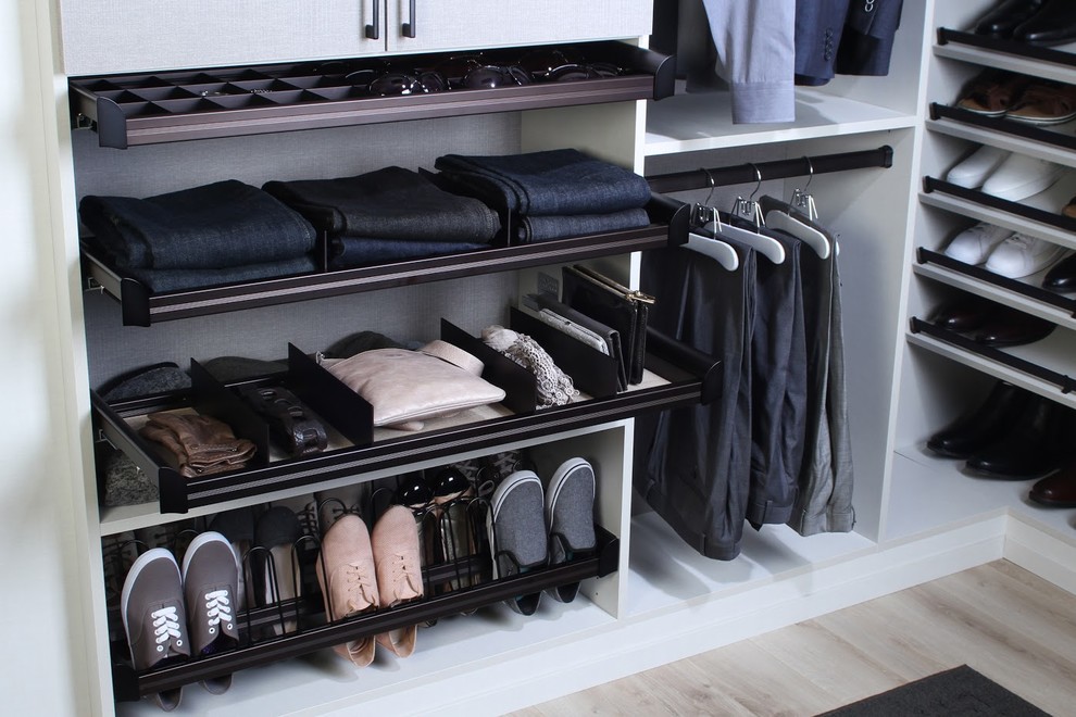 This is an example of a large contemporary gender-neutral walk-in wardrobe in Dallas with open cabinets, light hardwood floors and beige floor.