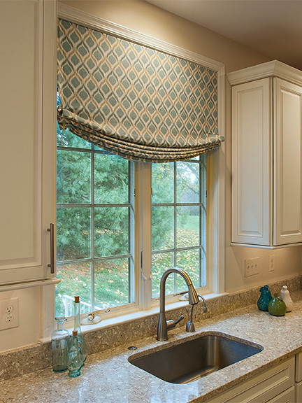 Eat-in kitchen - mid-sized transitional medium tone wood floor eat-in kitchen idea in Philadelphia with a drop-in sink, raised-panel cabinets, white cabinets, an island, granite countertops, white backsplash and stainless steel appliances