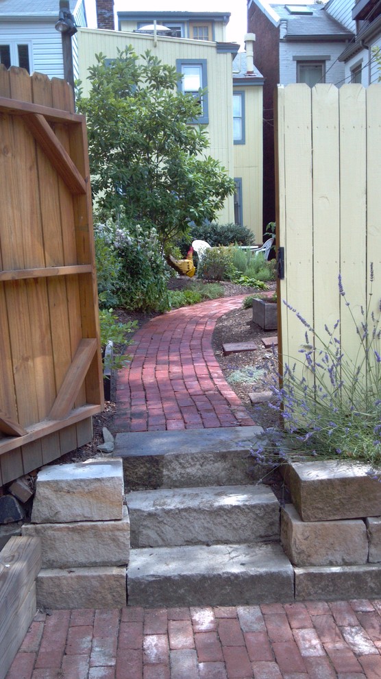 Photo of a small traditional backyard full sun formal garden for summer in Other with a garden path and brick pavers.