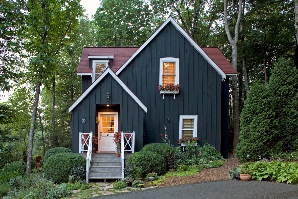 This is an example of a traditional two-storey black exterior in Charlotte with wood siding.