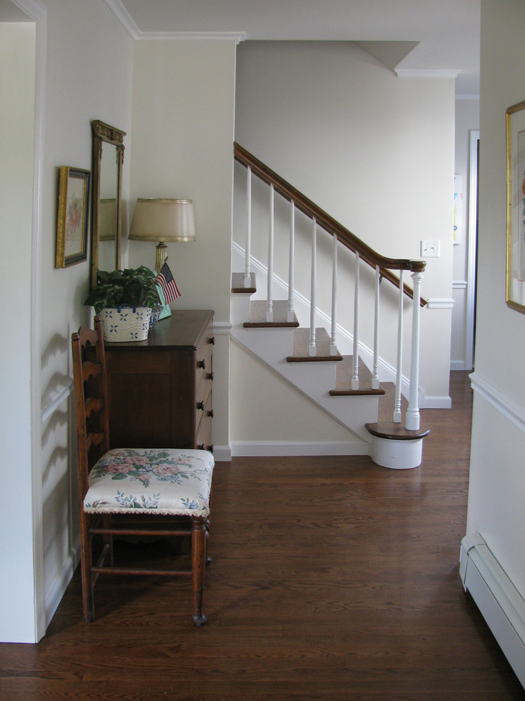 Design ideas for a mid-sized traditional wood straight staircase in New York with painted wood risers.