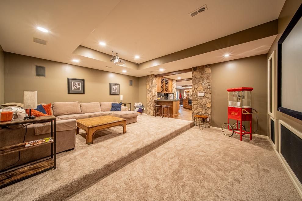 Design ideas for a large rustic walk-out basement in Other with a home cinema, brown walls, vinyl flooring, a standard fireplace, a stone fireplace surround, brown floors and exposed beams.