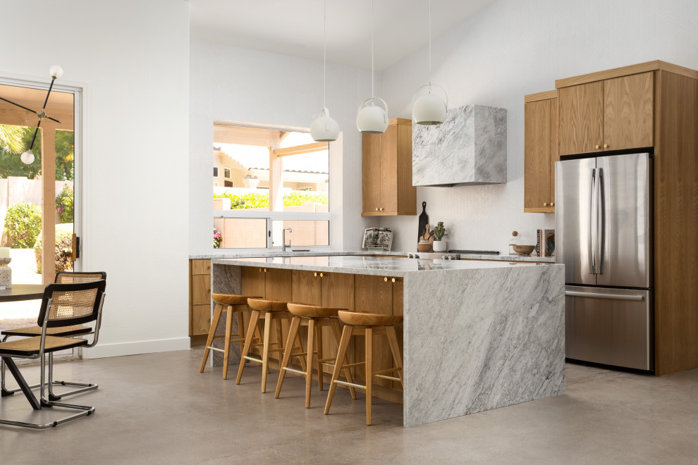 Inspiration for a scandinavian kitchen in Phoenix with flat-panel cabinets, medium wood cabinets, marble benchtops, white splashback, mosaic tile splashback, stainless steel appliances, with island, grey floor, grey benchtop and vaulted.