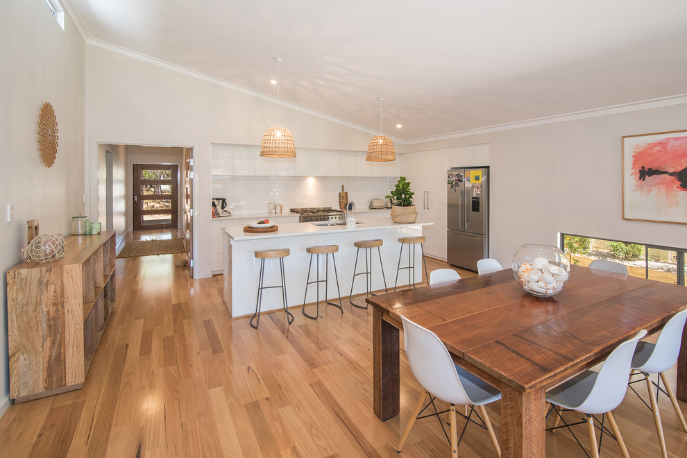 Mid-sized transitional open plan dining in Perth with white walls and light hardwood floors.