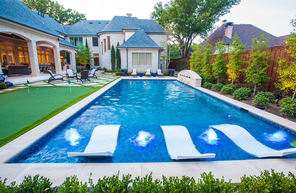 Photo of a mid-sized mediterranean backyard rectangular lap pool in Dallas with a water feature and concrete pavers.