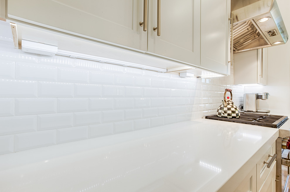 Example of a large transitional galley open concept kitchen design in Phoenix with shaker cabinets and an island