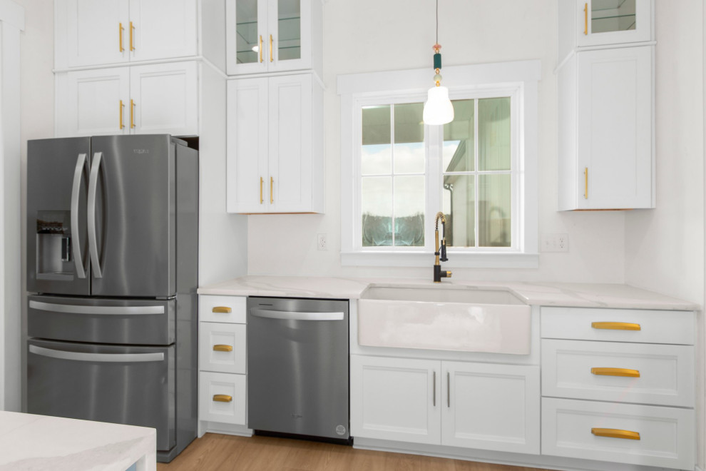 Example of a large transitional l-shaped open concept kitchen design in Richmond with a farmhouse sink, recessed-panel cabinets, quartz countertops, white backsplash, stainless steel appliances, an island and white countertops