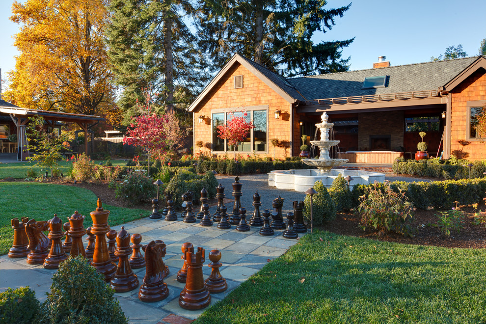 This is an example of a transitional garden in Portland with a water feature.