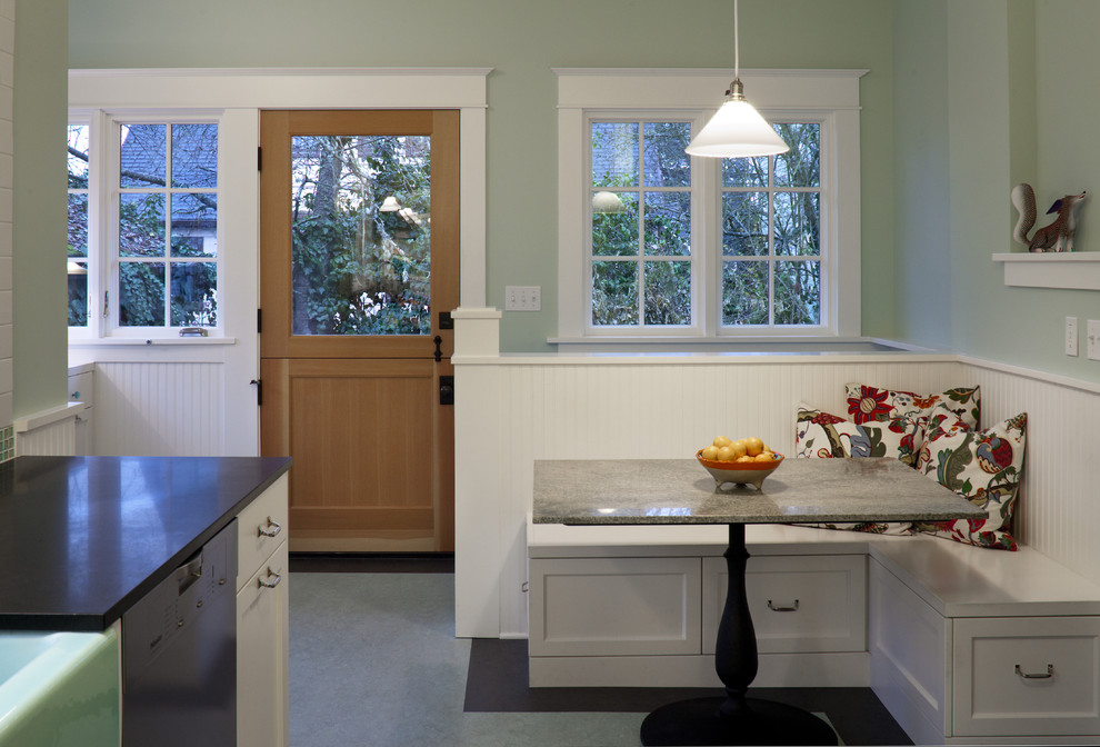 Mid-sized arts and crafts galley eat-in kitchen in Portland with shaker cabinets, white cabinets, granite benchtops, white splashback, subway tile splashback, stainless steel appliances, linoleum floors, no island and a farmhouse sink.