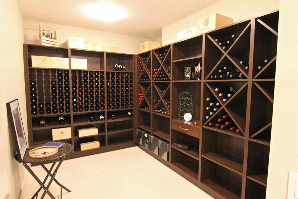 This is an example of a large traditional wine cellar in Calgary with linoleum floors and storage racks.