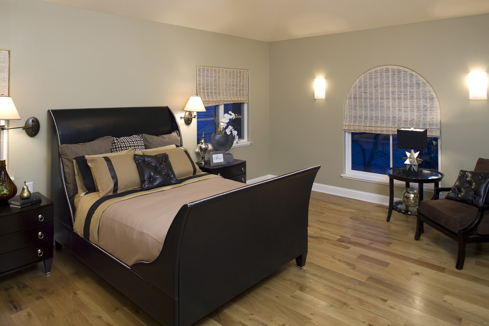 This is an example of a traditional bedroom in Minneapolis with grey walls and light hardwood floors.