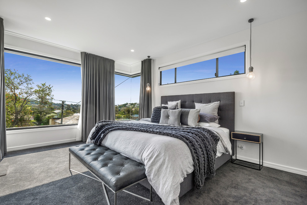 Photo of a large contemporary master bedroom in Brisbane with white walls, carpet and grey floor.