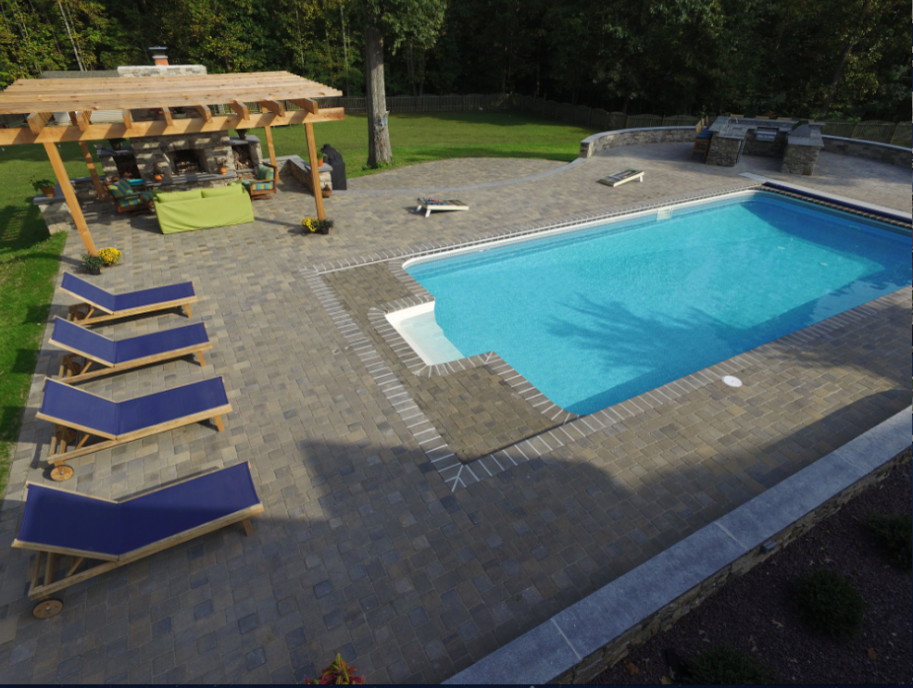 Pool - large transitional backyard brick and rectangular pool idea in DC Metro