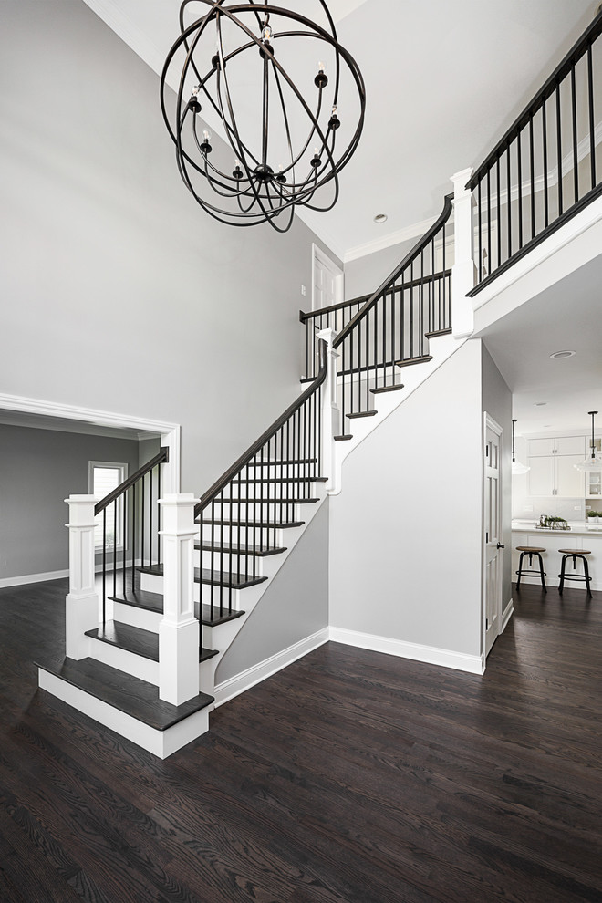 Photo of a large transitional foyer in Chicago with grey walls, light hardwood floors and grey floor.