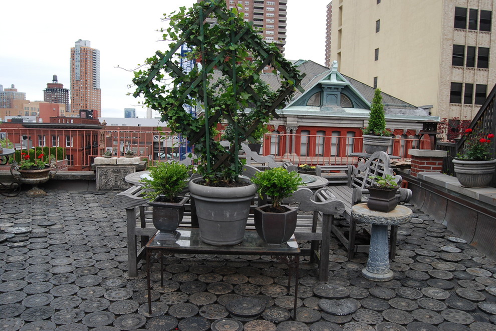 This is an example of a small transitional rooftop full sun garden for summer in New York with a container garden.