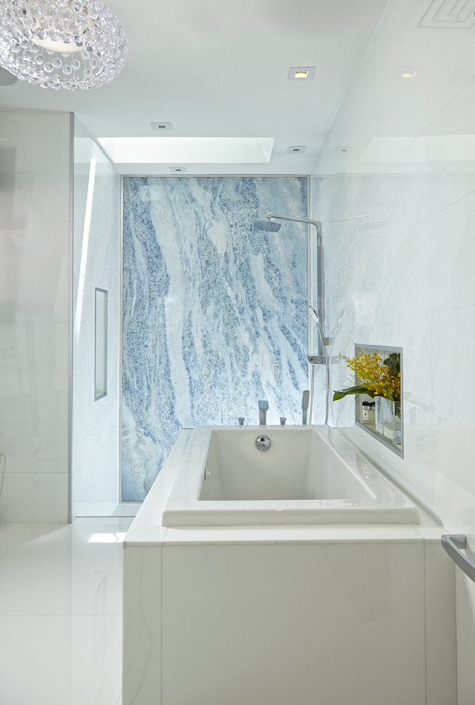 Large contemporary master bathroom in Miami with flat-panel cabinets, white cabinets, a corner tub, an open shower, a one-piece toilet, multi-coloured tile, stone slab, multi-coloured walls, marble floors, a drop-in sink and glass benchtops.