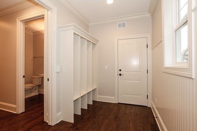 Design ideas for a transitional mudroom in Chicago with grey walls, medium hardwood floors, a single front door and a black front door.