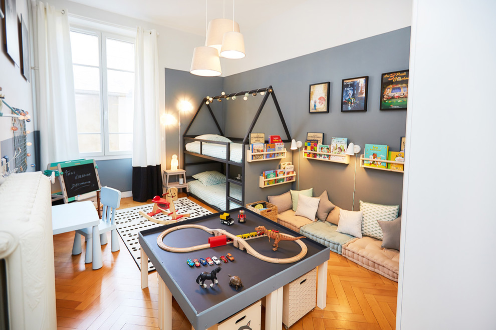 Design ideas for a large transitional kids' bedroom for kids 4-10 years old and boys in Other with medium hardwood floors, brown floor and multi-coloured walls.