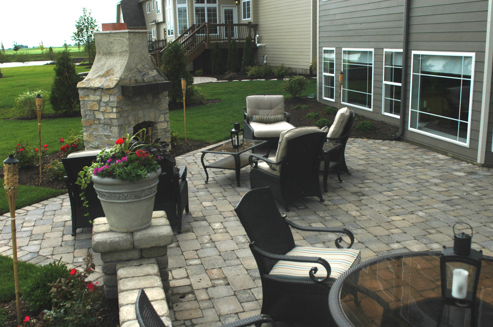 Design ideas for a large arts and crafts backyard patio in Chicago with a fire feature, concrete pavers and no cover.