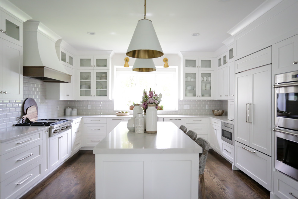 Inspiration for a large transitional u-shaped eat-in kitchen in Indianapolis with recessed-panel cabinets, white cabinets, quartz benchtops, white splashback, subway tile splashback, with island and white benchtop.
