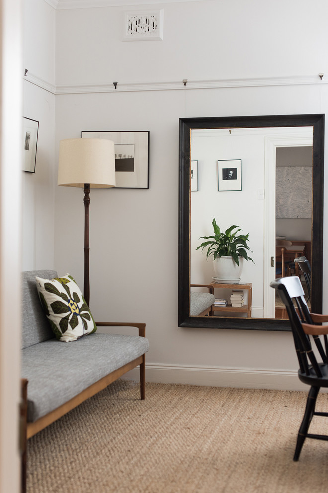 Photo of a small midcentury study room in Sydney with white walls, medium hardwood floors, no fireplace and a freestanding desk.