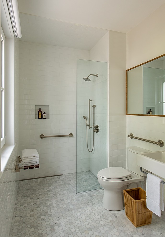 Inspiration for a mid-sized contemporary 3/4 bathroom in Boston with a curbless shower, a two-piece toilet, white tile, subway tile, white walls, a wall-mount sink, grey floor and an open shower.