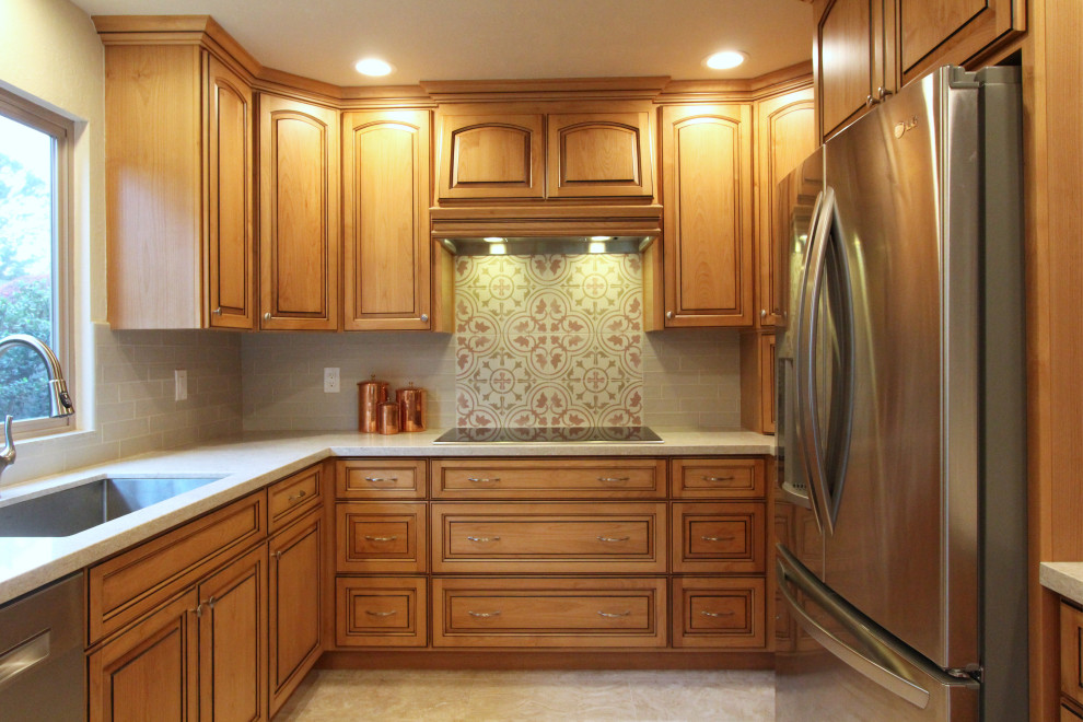 Example of a mid-sized u-shaped porcelain tile and beige floor eat-in kitchen design with an undermount sink, raised-panel cabinets, medium tone wood cabinets, quartz countertops, multicolored backsplash, ceramic backsplash, stainless steel appliances, a peninsula and multicolored countertops