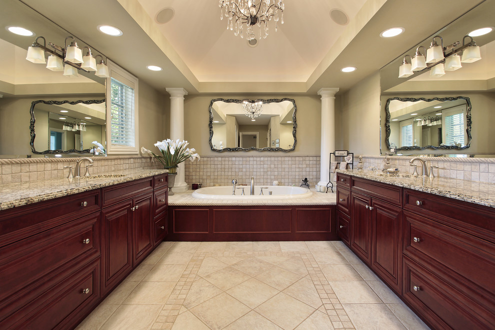 Large traditional master bathroom in Atlanta with an undermount sink, raised-panel cabinets, red cabinets, granite benchtops, an alcove tub, a corner shower, a two-piece toilet, beige tile, porcelain tile, beige walls and porcelain floors.