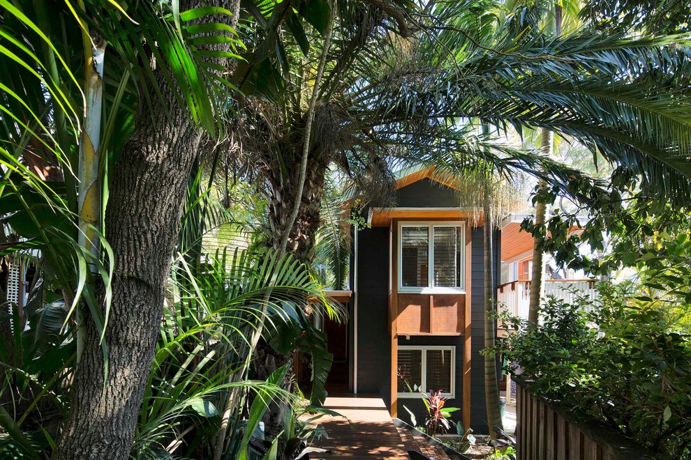 Inspiration for a mid-sized tropical two-storey blue house exterior in Sydney with wood siding, a gable roof and a metal roof.
