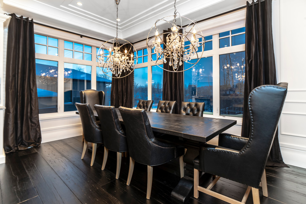 This is an example of a transitional dining room in Edmonton with white walls and dark hardwood floors.