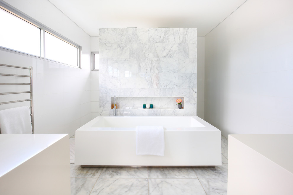 This is an example of a contemporary master bathroom in Sydney with a freestanding tub, white walls and an open shower.