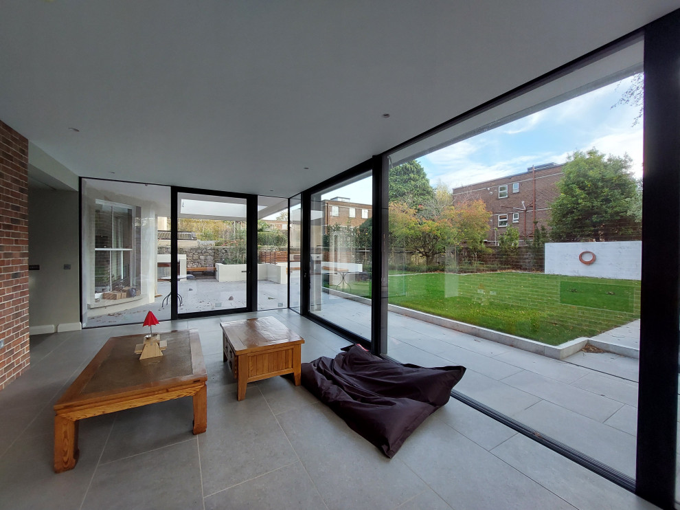 Contemporary glazed extension connects historic house to garden